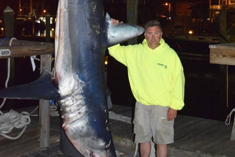Fred Dirsh Jr. posing with the 800-pound Mako shark. (Photo courtesy of South Jersey Marina)