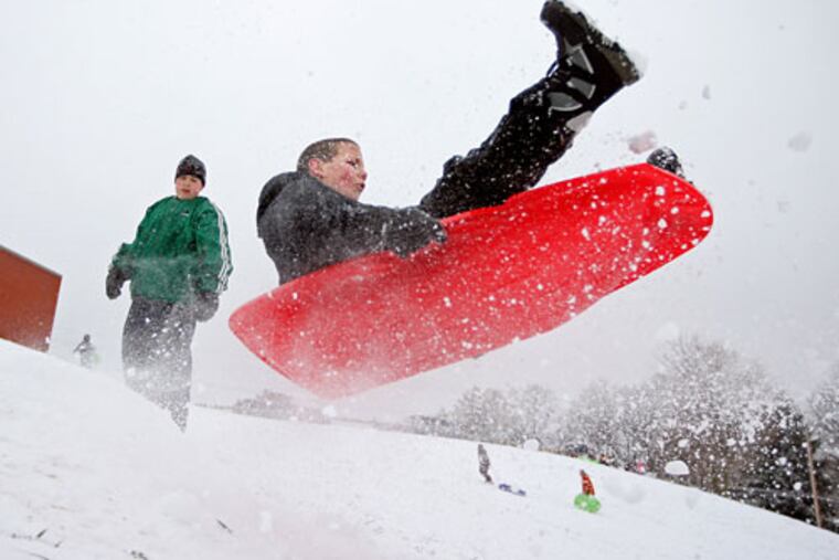 Anthony Marinelli, then 13, of Wallingford, launches off a snow ramp he and his friends built next to Strath Haven High School in 2009.