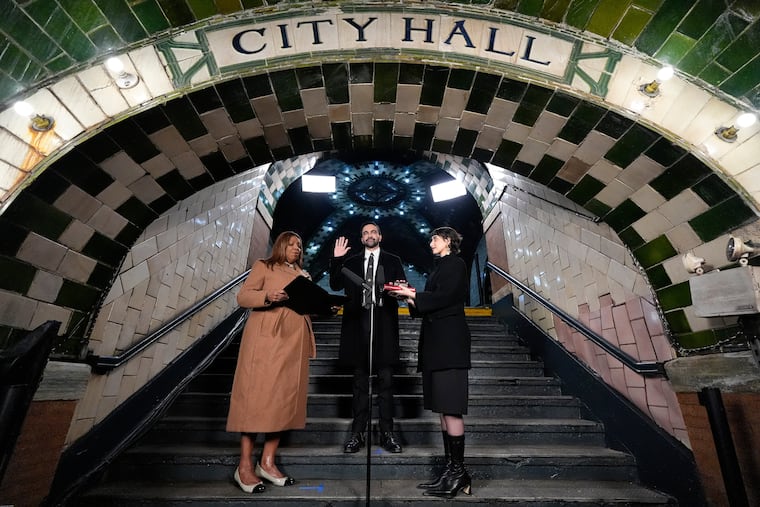 FILE - New York Attorney General Letitia James, left, administers the oath of office to mayor-elect Zohran Mamdani, center, as his wife Rama Duwaji looks on, Jan. 1, 2026, in New York. (AP Photo/Yuki Iwamura, File)