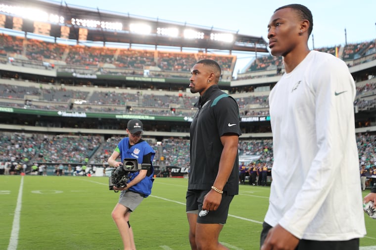 Eagles quarterback Jalen Hurts (left) and DeVonta Smith on the sideline of an NFL preseason football game against the Browns at Lincoln Financial Field, Thursday, Aug. 17, 2023, in Philadelphia.