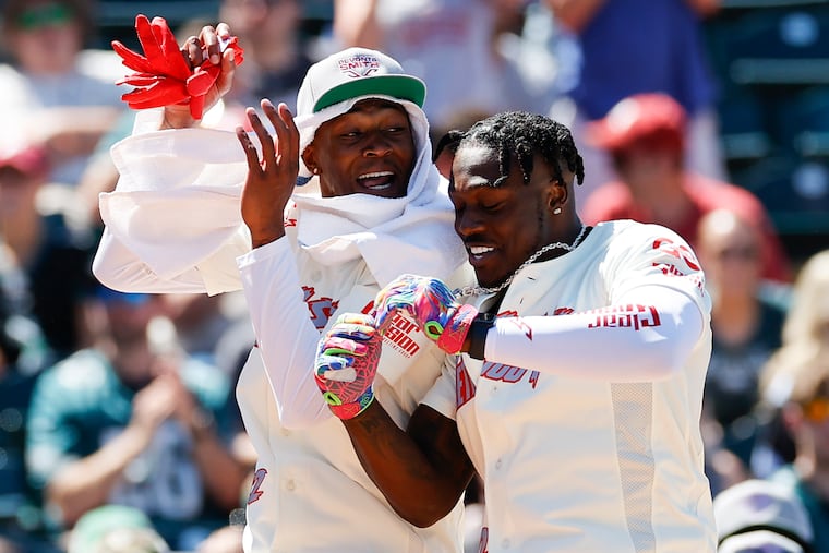 A.J. Brown (right) celebrates his home run derby contest win with teammate DeVonta Smith during the DeVonta Smith celebrity softball game at Coca-Cola Park in Allentown on Saturday, June 4, 2022.