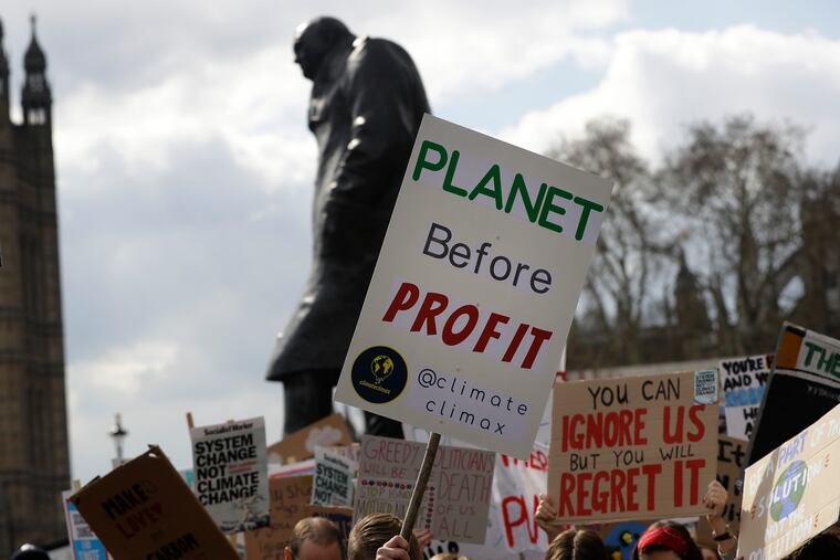 Climate change demonstrators hold banners in April in front of the Winston Churchill Statue during a protest near Parliament in London.