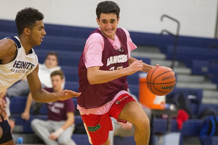 Holy Cross Prep’s Gianmarco Arletti, right, drives up court during a scrimmage against St. Augustine Prep on Dec.6, 2018. CHARLES FOX / Staff Photographer