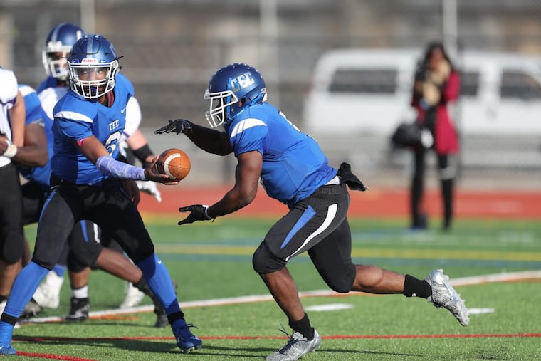 Conwell-Egan quarterback Alex Goldsby hands off to Patrick Garwo. Garwo scored a touchdown on the play.