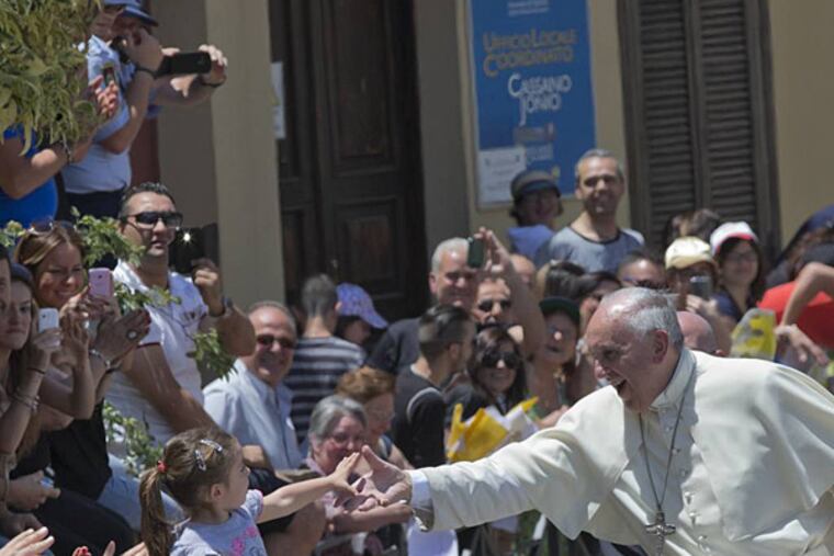 Pope Francis salutes faithful in Cassano allo Jonio, southern Italy, Saturday, June 21, 2014. Pope Francis is paying a one day visit to Castrovillari, Sibari, and Cassano allo Jonio, in the Calabria region of Italy. (AP Photo/Alessandra Tarantino)