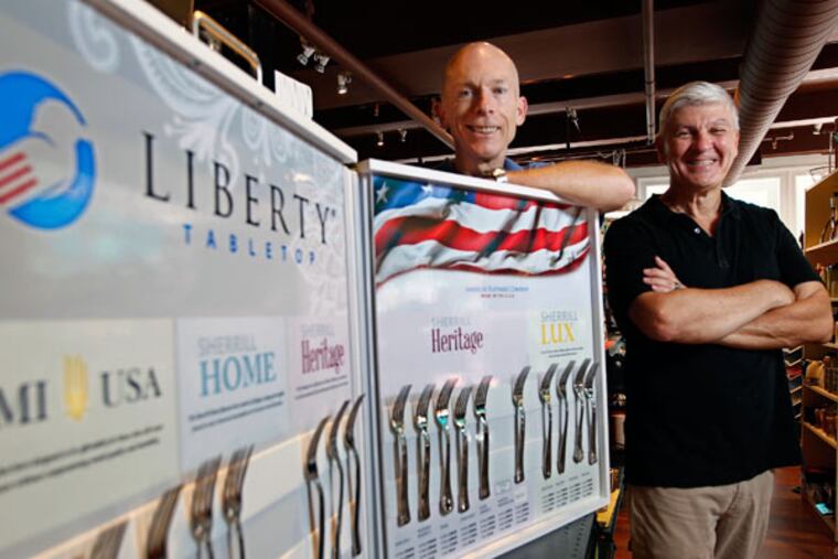 Robert Hanlon (left) is one of the investors in Liberty Flatware with Bob Smith, owner of Kitchenette in Center City, which sells Liberty Tabletop, the only made-in-USA silverware. (MICHAEL BRYANT / STAFF PHOTOGRAPHER)