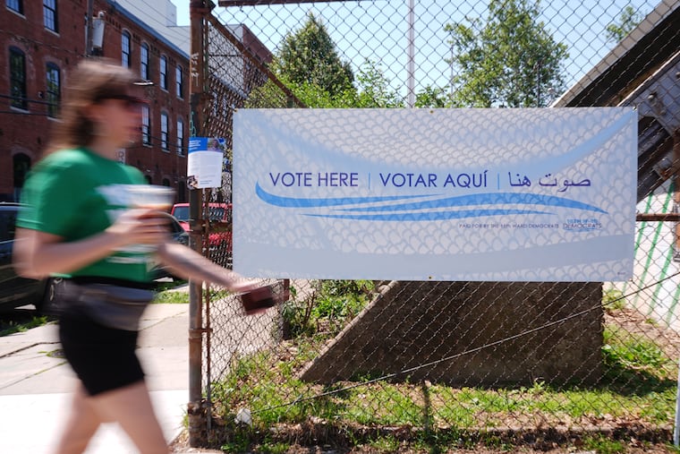 A person walks outside a polling place in Philadelphia in May. Turnout citywide for the primaries was just 22.3% — a drop from four years ago, writes Omar Sabir.