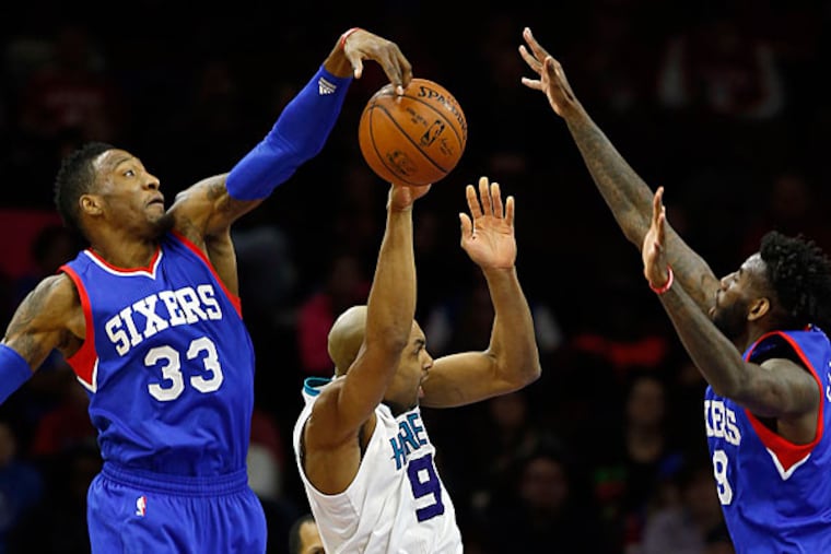 Sixers' Robert Covington and JaKarr Sampson defend Charlotte Hornets'
Gerald Henderson in the first-period on Saturday, February 7, 2015 in
Philadelphia. (Yong Kim/Staff Photographer)