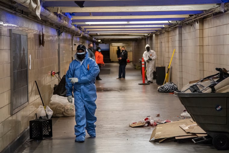 Members of the Department of Public Property clean PATCO's 12/13th & Locust Street Station in 2021.