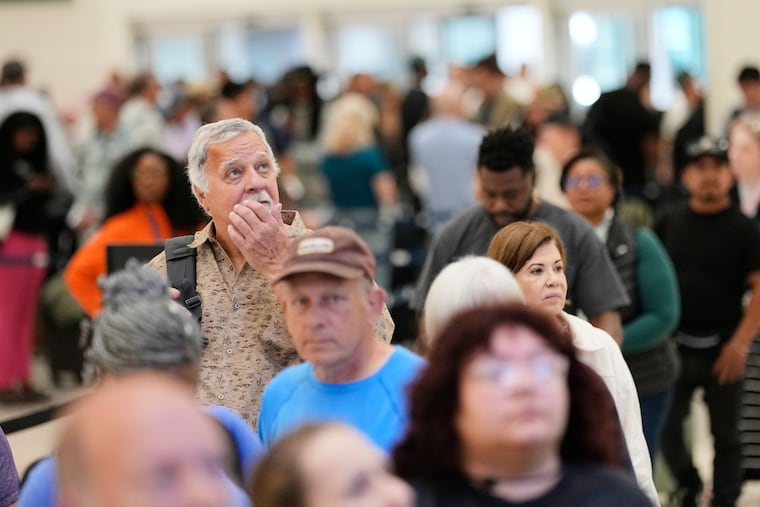 Passengers wait in a security checkpoint line at George Bush Intercontinental Airport, Wednesday, March 25, 2026, in Houston. (AP Photo/David J. Phillip)