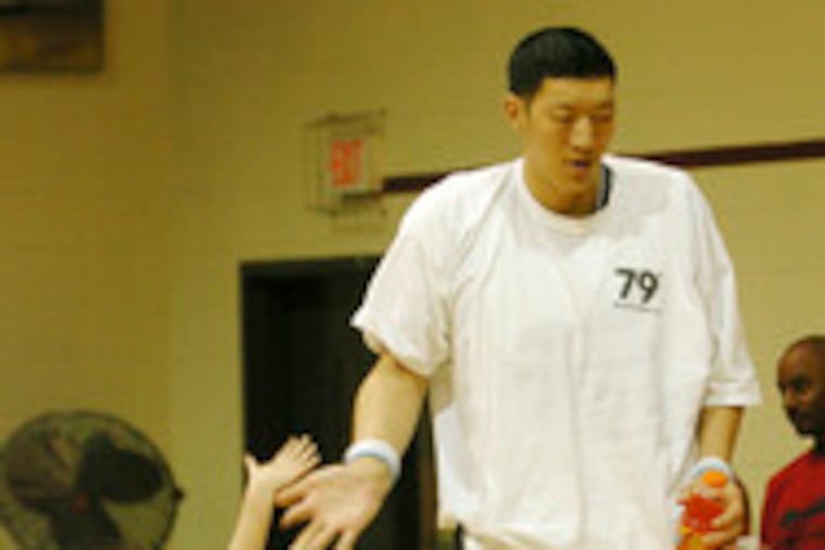 Sun Ming Ming and a young fan before recent ABA game in Rockville, Md.