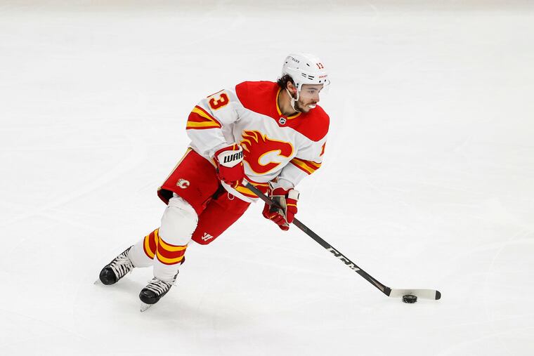 Calgary Flames left wing Johnny Gaudreau (13) looks to pass the puck against the Chicago Blackhawks during the first period of an NHL hockey game, Monday, April 18, 2022, in Chicago. (AP Photo/Kamil Krzaczynski)