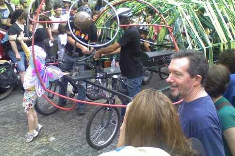 Leandra Brinkmann, 6, dressed as a butterfly, has a starring role in the homage to "The Very Hungry Caterpillar" that her family created with friends using plastic piping and bikes.