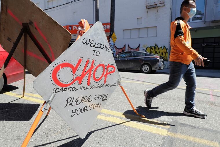 A sign welcomes visitors ear an entrance to what has been named the Capitol Hill Occupied Protest zone in Seattle.