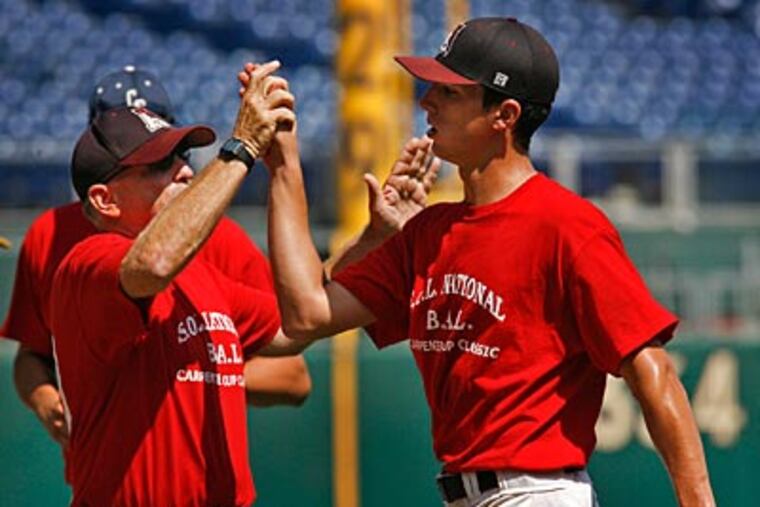 SOL National / Bicentennial pitcher Jake Ruch and assistant coach Dave Torresani celebrate after defeating SOL American & Continental. (Alejandro A. Alvarez / Staff Photographer)