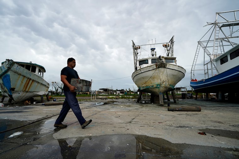 Mike Bartholemey places extra blocks under his recently dry docked shrimp boat, out of concern for strong winds, in Empire, La., on Sunday in advance of Hurricane Marco's expected arrival.
