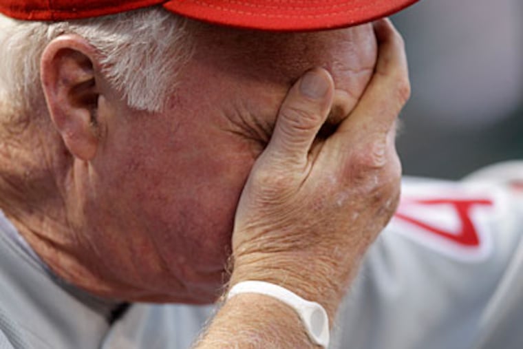 Phillies manager Charlie Manuel can't look during the third inning of the team's loss to the Cardinals. (AP Photo / Jeff Roberson)