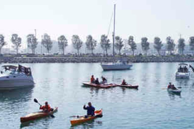 Souvenir hunters take their positions in McCovey Cove before Game 3 of the National League Championship Series.