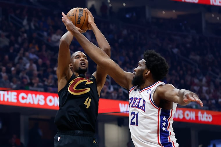 Cleveland Cavaliers forward Evan Mobley (4) shoots against Philadelphia 76ers center Joel Embiid (21).