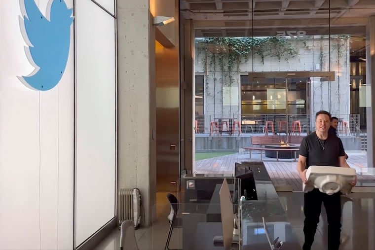 This image from the Twitter page of Elon Musk shows Musk entering Twitter headquarters carrying a sink through the lobby area on Wednesday in San Francisco.