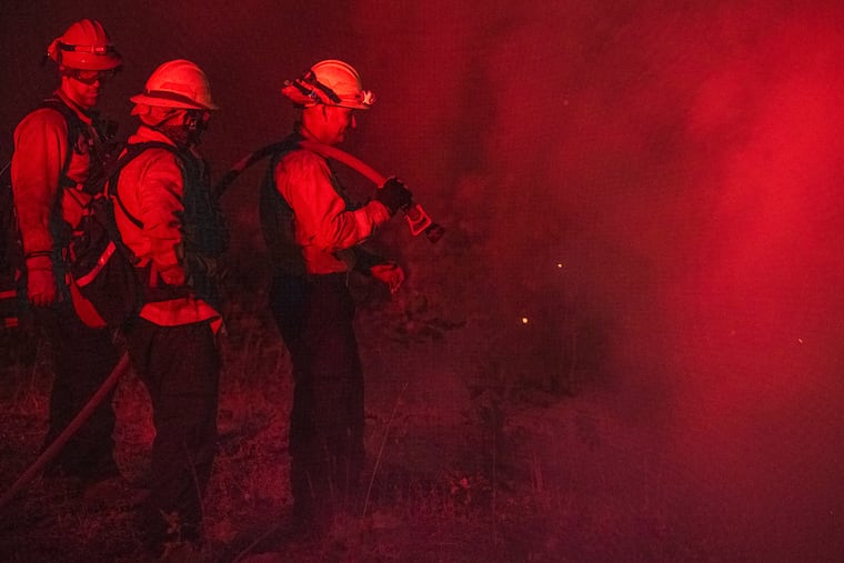 A fire crew from the city of Monterey monitors flareups on the Park Fire near Butte Meadows, Calif., on Sunday.