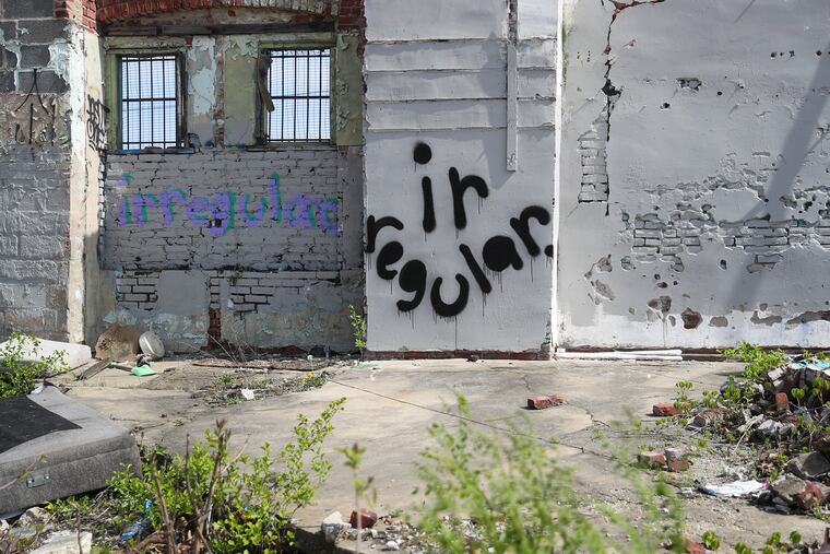 An “irregular” tag by Sean Hassett, who goes by artist name Irregular, is seen along N. 33rd St. by Oxford St. in Philadelphia on Wednesday, April 19, 2023.