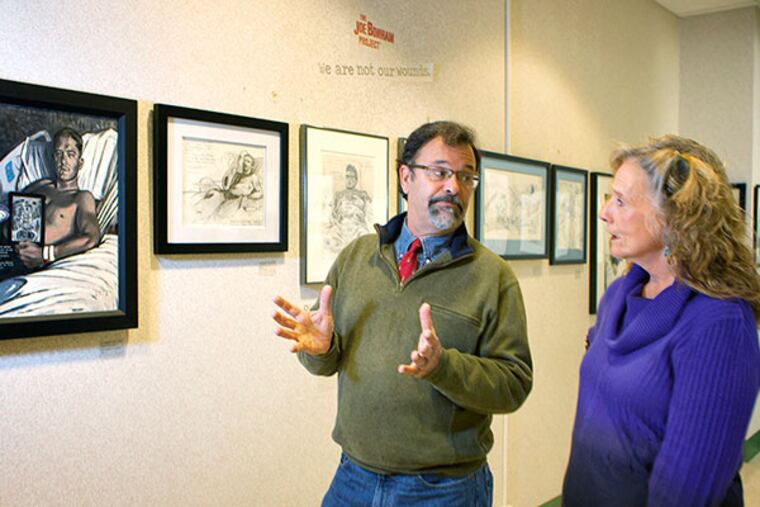 Drexel University opens The Joe Bonham Project, a collection of 40 drawings and paintings of severely wounded veterans of the Iraq and Afghan wars, as part of a new class on images of war and how people absorb and make sense of those pictures and videos. Here, Mike Fay, the former Marine who created the project, talks about the work with Karen Curry, who is teaching the class on war images at Drexel. ( Ed Hille / Staff Photographer)