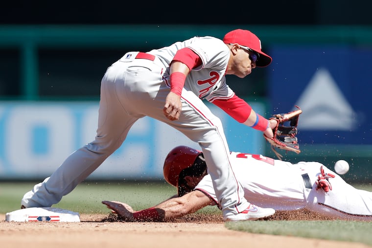 Cesar Hernandez misses the throw as the Nationals' Adam Eaton slides into second base on a third-inning steal.