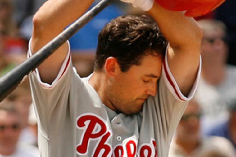 Pat Burrell pauses to wipe away sweat before hitting a bases-empty homer in the second inning.