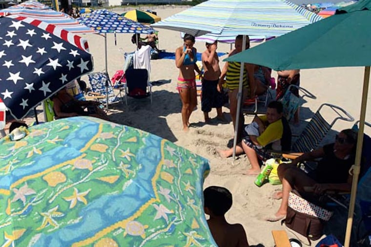 The Carr, Bentz, Helms, Wilson, and Robinson mothers and children seek some shade in Sea Isle City. Sit out in the sun? "We would look like leather," Anne Marie Robinson said.