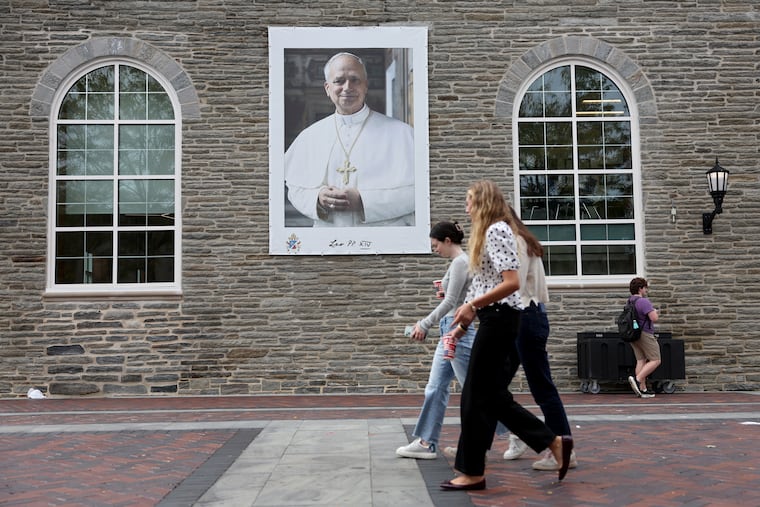 Students walk by a large poster of Pope Leo XIV at Villanova University in Villanova, Pa. on Wednesday, Sept. 30, 2026. Pope Leo attended Villanova.