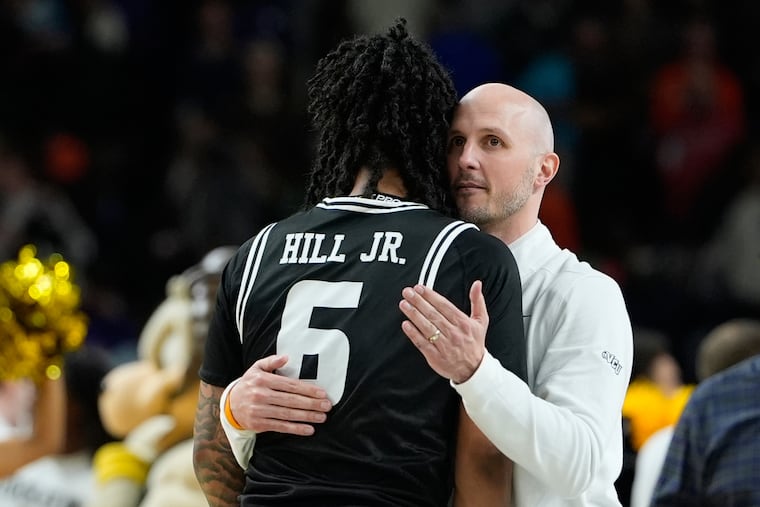 VCU guard Terrence Hill Jr. (left) hugs head coach Phil Martelli Jr. after their comeback overtime win over North Carolina in Greenville, S.C. on Thursday night.