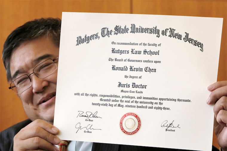 Ronald K. Chen, a co-dean of the Rutgers Law School, holds his new diploma issued by Rutgers Law School, not Rutgers-Newark or Rutgers-Camden. His name is on it twice, as graduate and signer. (ELIZABETH ROBERTSON/Staff Photographer)