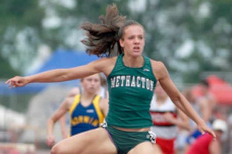Methacton's Ryann Krais clears the final hurdle in the Class AAA 300-meter hurdles. She also won the 100-meter hurdles.