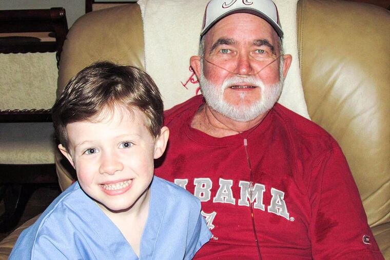 Jimmy Powell, after waiting in Philadelphia 15 months for a lung-liver transplant, returned home to Alabama. Grandson John Parker, 5, in hospital scrubs, plans to become a transplant surgeon. (Family Photo)