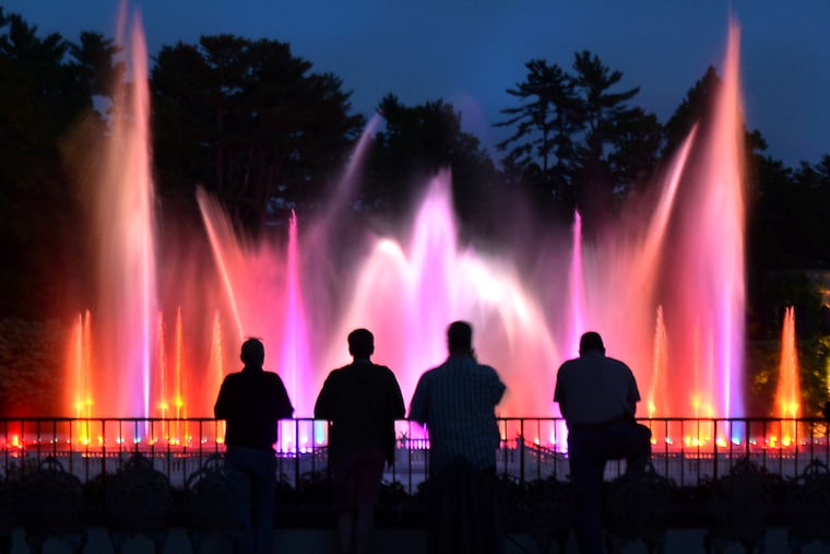 Staff members inspect the spectacular illuminated fountains choreographed to music at Longwood Gardens in Kennett Square on Tuesday evening May 16,2017.