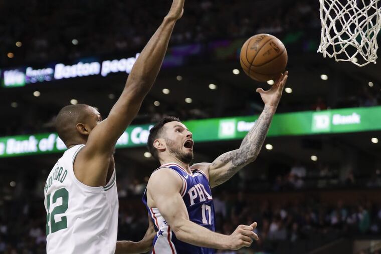 Philadelphia 76ers guard JJ Redick drives for a layup past Boston Celtics forward Al Horford during the third quarter of Game 2.