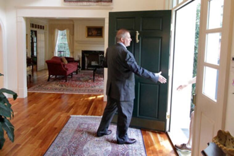 Duffy Real Estate associate broker Jim Hocker greets a man who came to the two hour open house at a Villanova home on September 9, 2012.