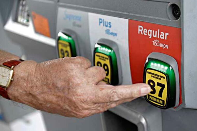 In this Wednesday, June 4, 2014 photo, Marty Mascio of Pembroke Pines, Fla., selects a grade of gasoline as he fills up his car at a Chevron station in Pembroke Pines. Violence in Iraq is pushing U.S. gasoline prices higher during a time of year they usually decline. The national average price of $3.67 per gallon is the highest price for this time of year since 2008, the year gasoline hit its all-time high. (AP Photo/Wilfredo Lee)