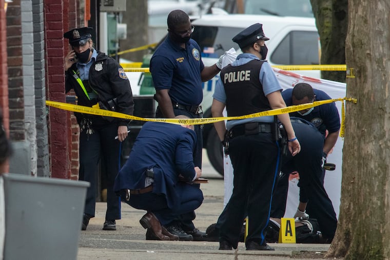 Philadelphia police and crime scene unit at scene of homicide on Knox St. near Hansberry in Germantown section of Philadelphia on Thursday afternoon March 25, 2021.