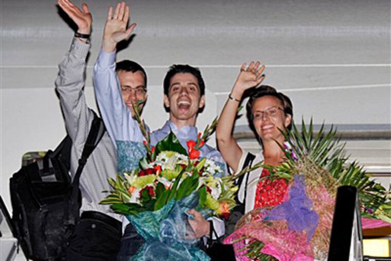 Freed Americans Shane Bauer, left, Josh Fattal, center, and Sarah Shourd, Bauer's fiance, wave from the door to an airplane before leaving for the United States at the airport in Muscat, Oman, Saturday, Sept. 24, 2011. They are scheduled to arrive in the U.S. today. (AP Photo/Sultan al-Hasani)