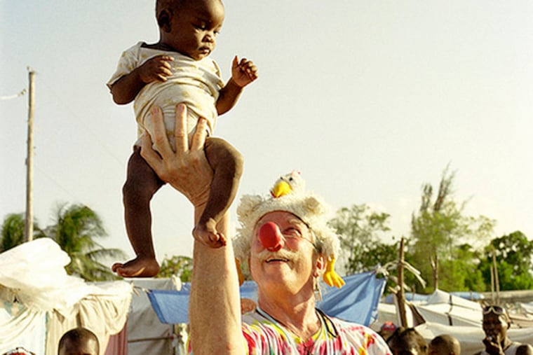 Patch Adams, with his ubiquitous red clown nose, during a visit to Afghanistan during the war. Dr. Adams – not Robin Williams, who played him in the 1998 blockbuster movie – is speaking in Philadelphia on Tuesday7/23 and Wednesday7/24 in support of a proposed Patch Adams Free Clinic, the first of what local organizers dream will be a movement of clinics in his name nationwide. CREDIT: Courtesy of Gesundheit! Institute