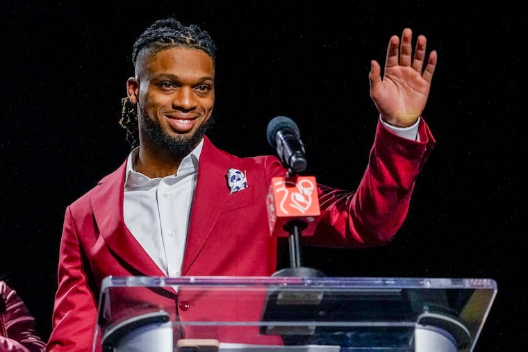 Damar Hamlin waves after being introduced as the winner of the Alan Page Community Award during a news conference Wednesday.