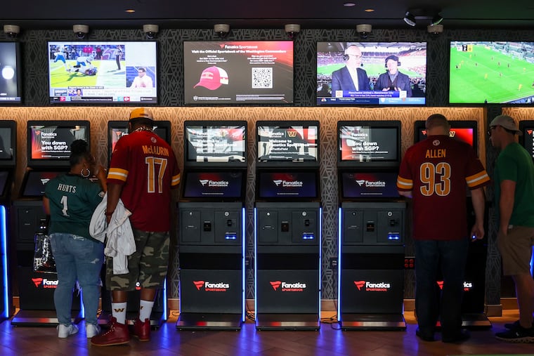Betting machines line the wall at the Fanatics Sportsbook at FedEx Field in Landover, Md., on Sunday.