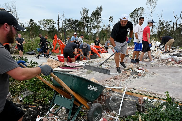 Anthony Dagrosa sweeps up what's left of his flattened home on Salvatore Drive in Mullica Hill on Sunday. His neighbors and volunteers helped him clean up following the destruction from a tornado spawned by the remnants of Hurricane Ida.