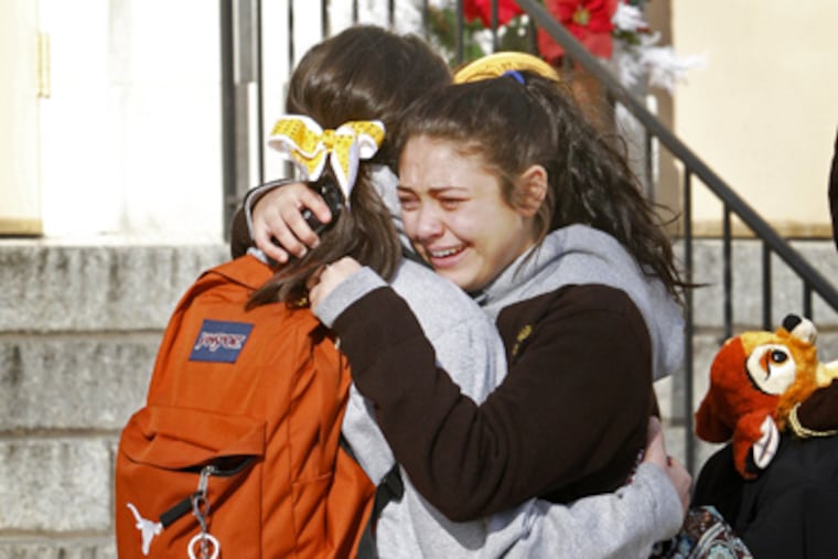 Students from St. Hubert High School console each other after leaving school Friday after learning that their school will close. (Alejandro A. Alvarez / Staff Photographer)