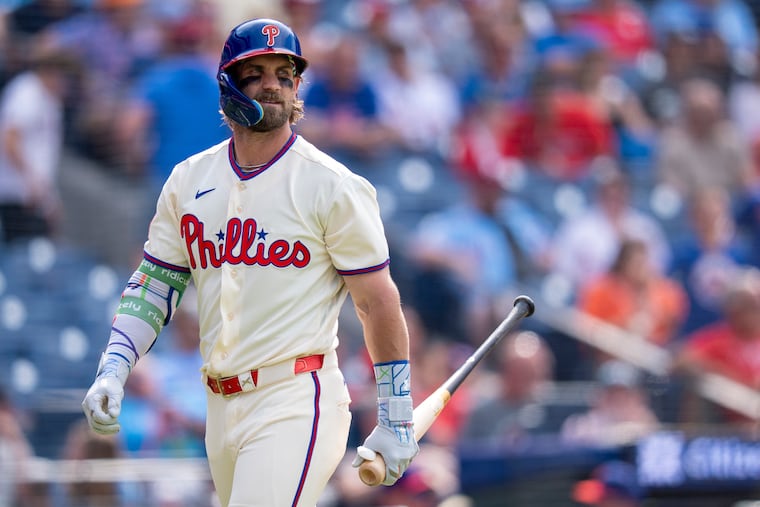 Philadelphia Phillies' Bryce Harper looks back after striking out to end the eighth inning of a baseball game against the New York Mets, Sunday, July 19, 2026, in Philadelphia. (AP Photo/Chris Szagola)