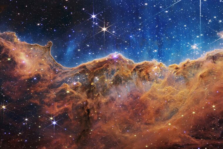 This image released by NASA on Tuesday shows the edge of a nearby, young, star-forming region NGC 3324 in the Carina Nebula.