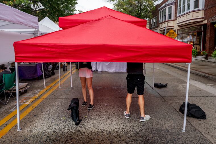 August 29, 2022: Merchants close up their tent as a light rain begins to fall at a street fair in Collingswood.