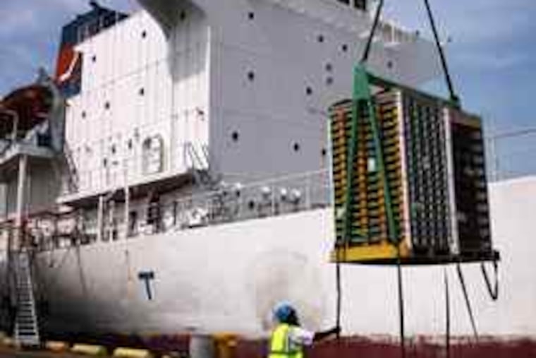 A stevedore unloads citrus from South Africa at Gloucester Terminals. South African producers are planning to ship 20 percent more fruit through the region this summer because, for the first time, some of it will be sent to the West Coast. The increase means local jobs in the slow season.
